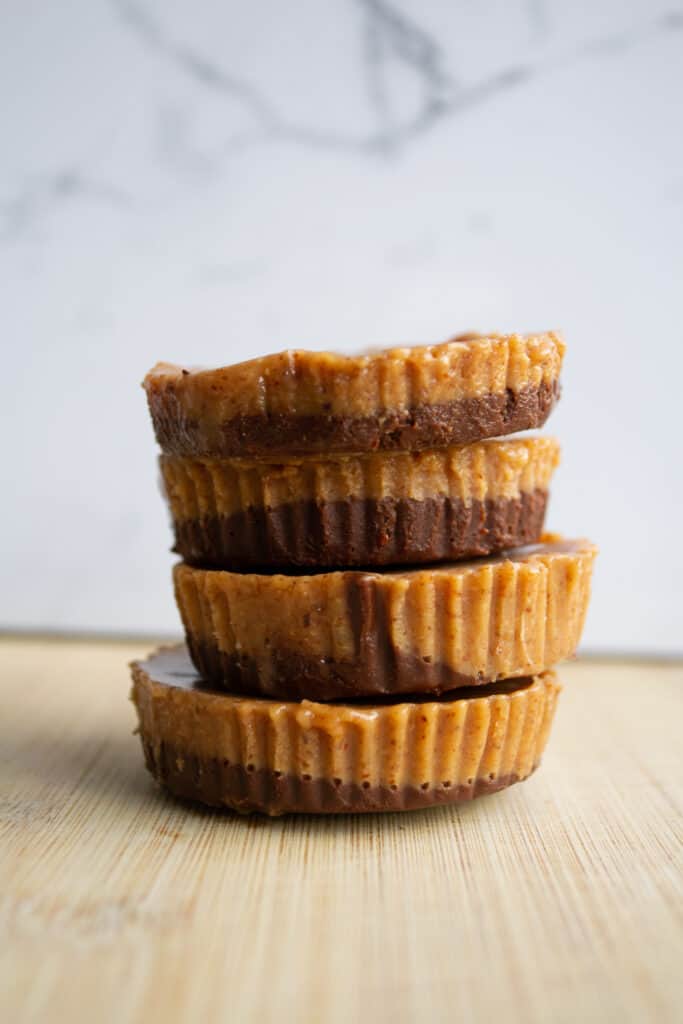 raw vegan almond butter cups in a stack