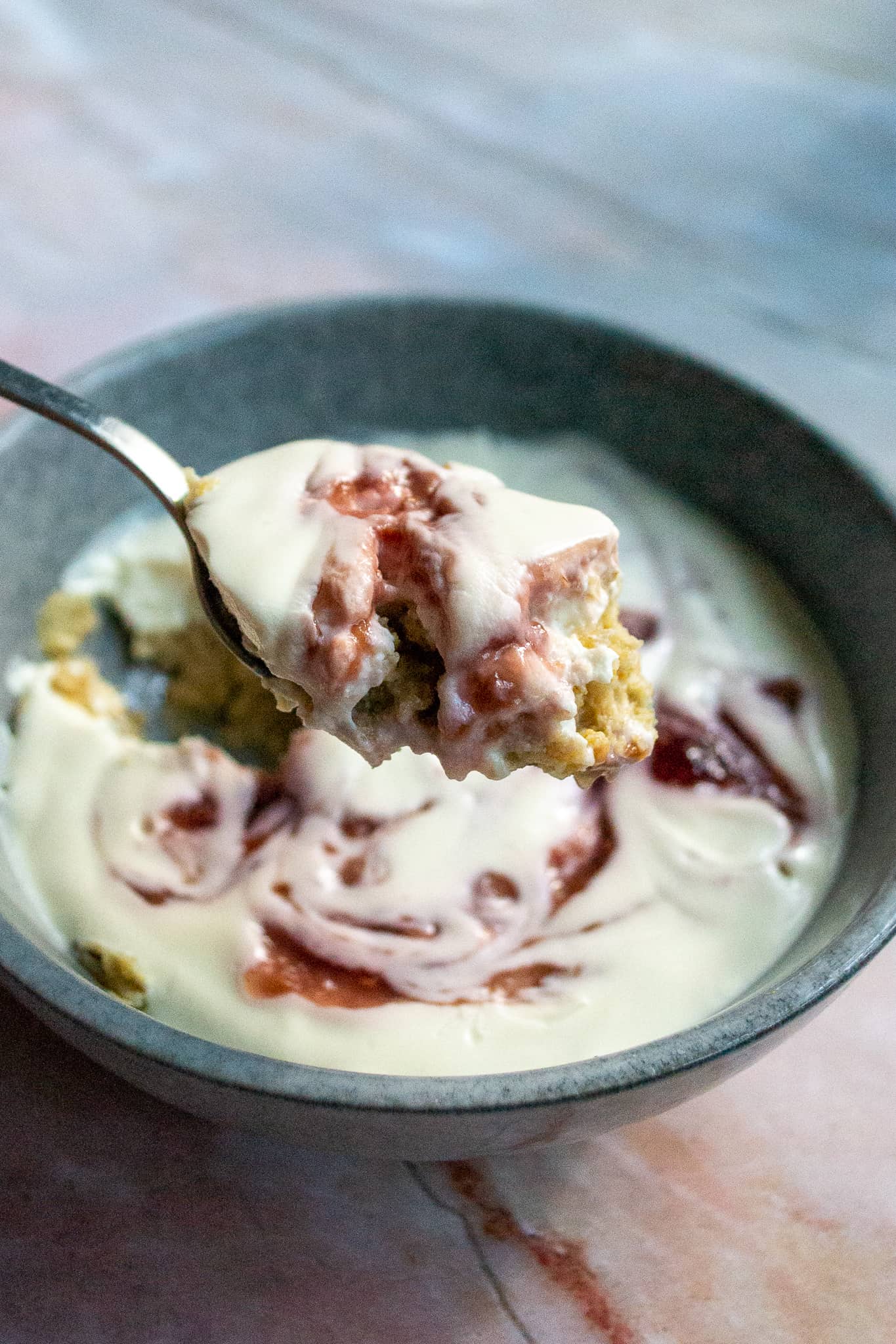 Overnight Weetabix in a bowl with a spoon taking a bite out.