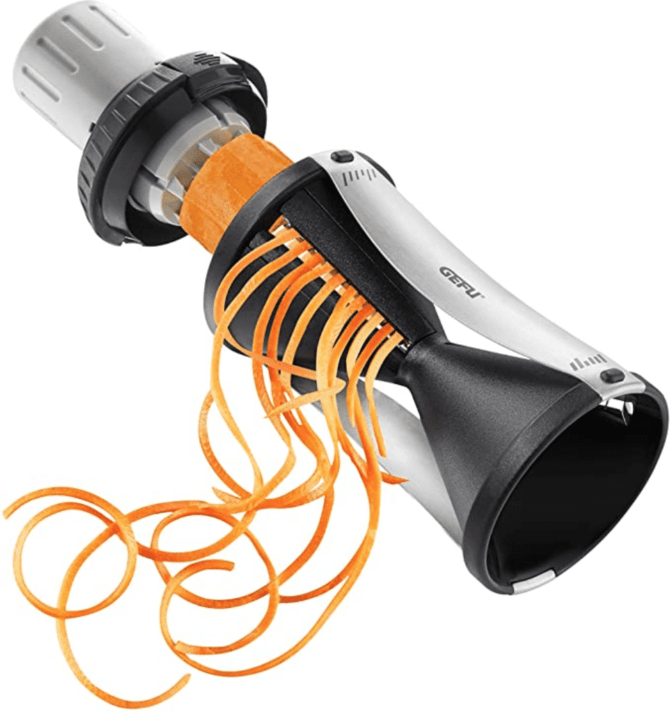 Vegetable spiralizer by the brand GEFU cutting a carrot into thin ribbons on a white background. 