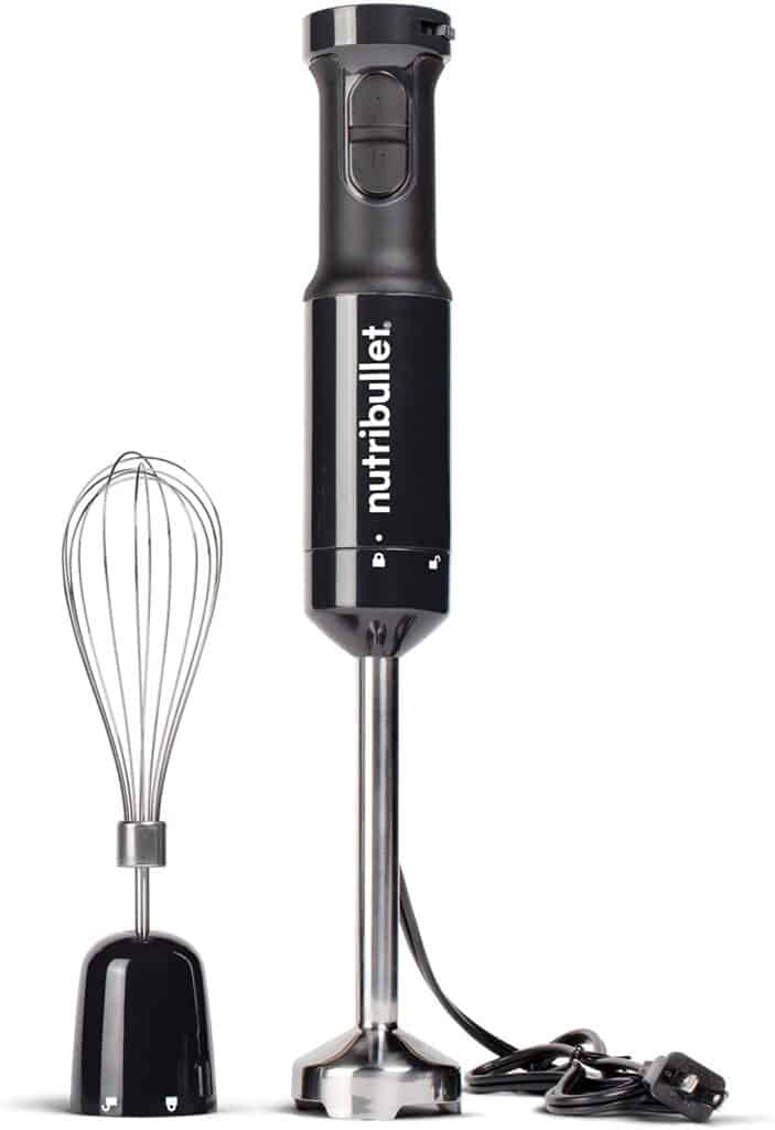 Product image of the NutriBullet immersion blender. The blender head is attached to the blender, and the whisk attachment is to the left of the immersion blender and blending head. 