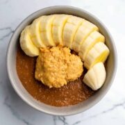 Blended overnight oats in a bowl with banana.