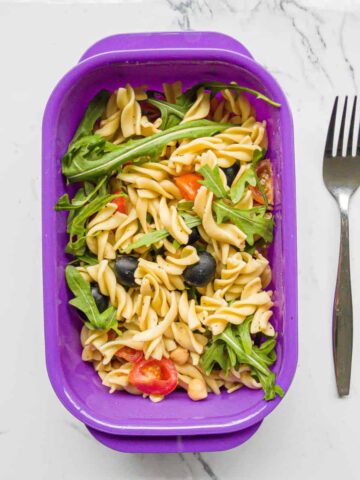 Pasta salad in a takeaway container.