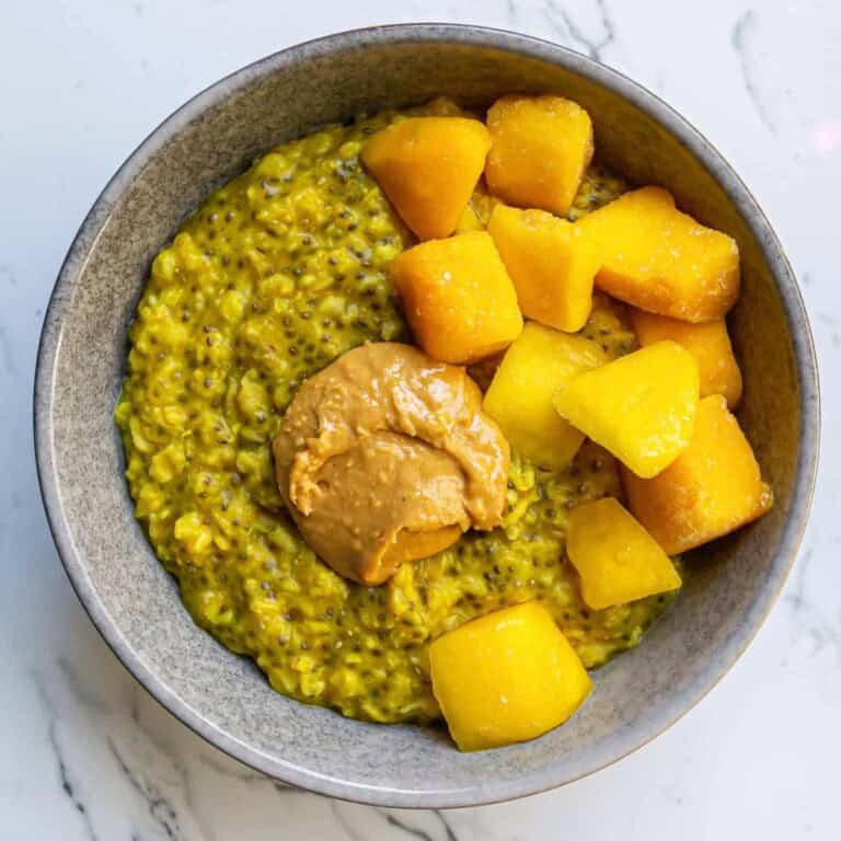 Creamy butternut squash soup with roasted pumpkin chunks and fresh herbs, served in a rustic bowl, highlighting healthy, seasonal ingredients for a cozy fall meal.