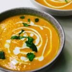 Pumpkin soup in a bowl with coconut milk.