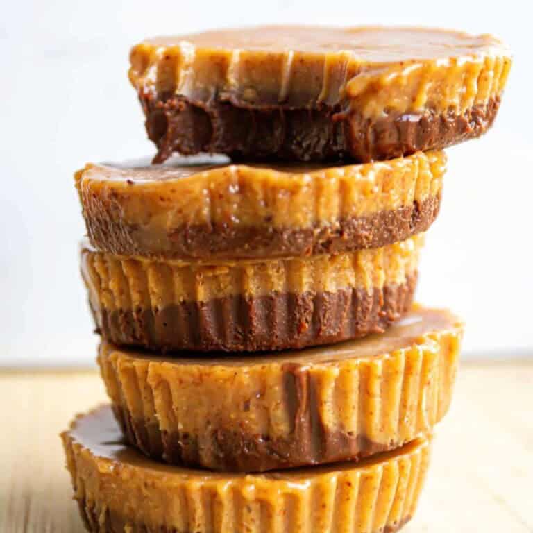 Rich caramel and chocolate layered cupcakes stacked, homemade caramel chocolate mini cakes, decadent dessert treats for special occasions, sweet confections with caramel and chocolate flavor, visually appealing handcrafted desserts for entertaining.