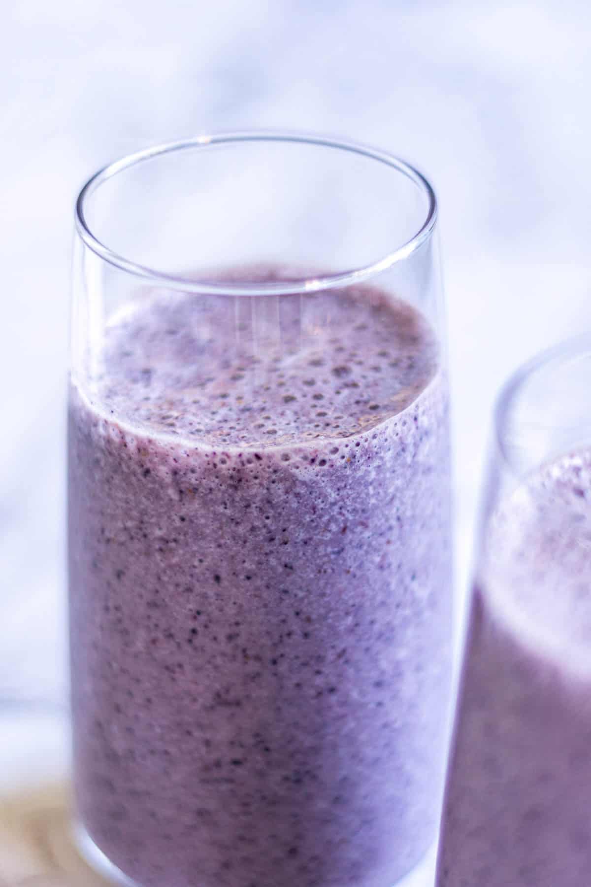 Close up of purple smoothie in a glass.