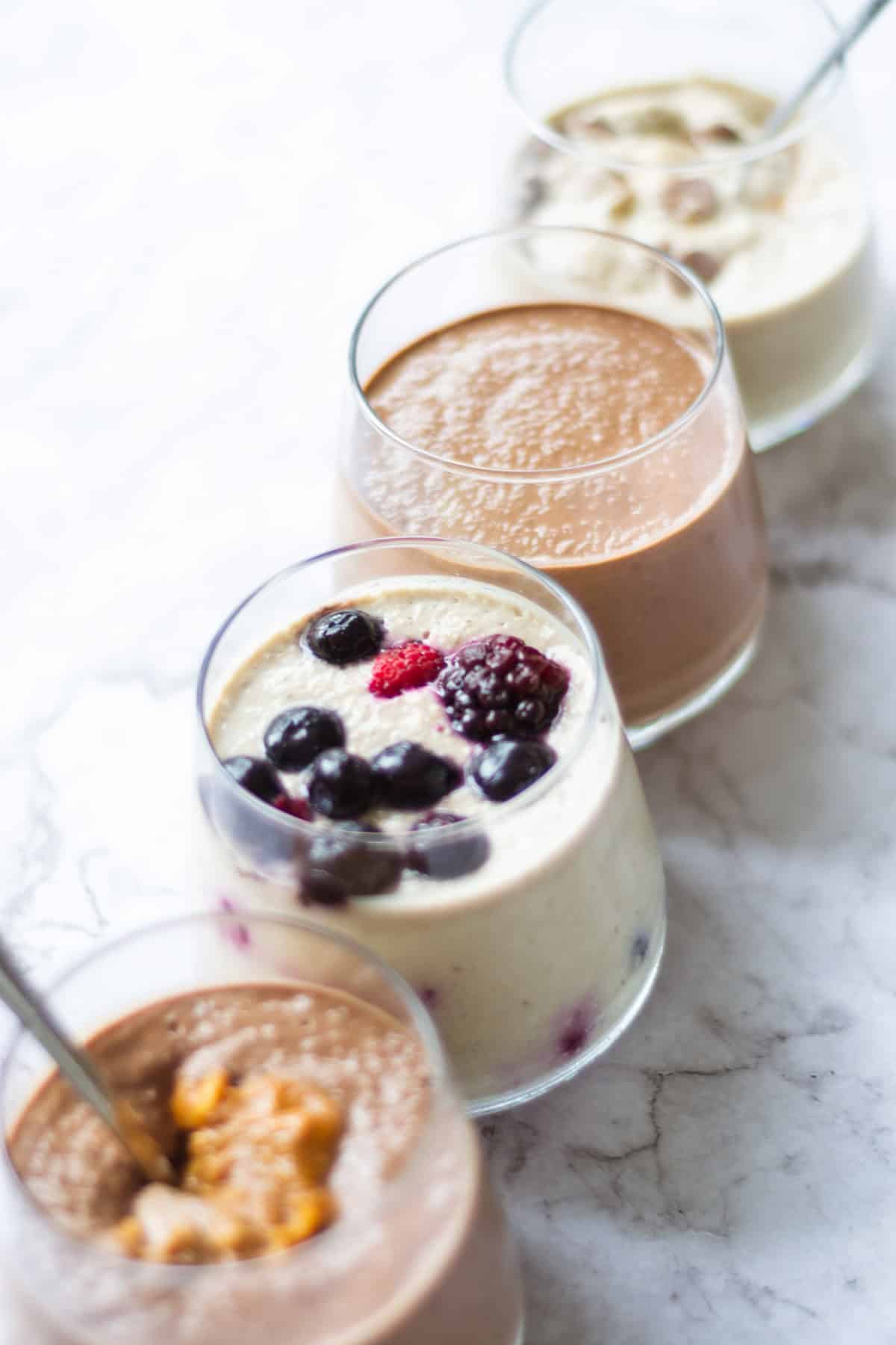 Front view of four flavours of overnight oats in a line.
