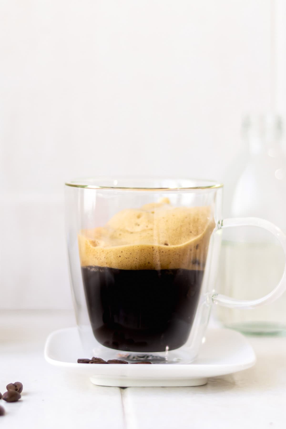 Iced shaken espresso in a clear coffee mug.
