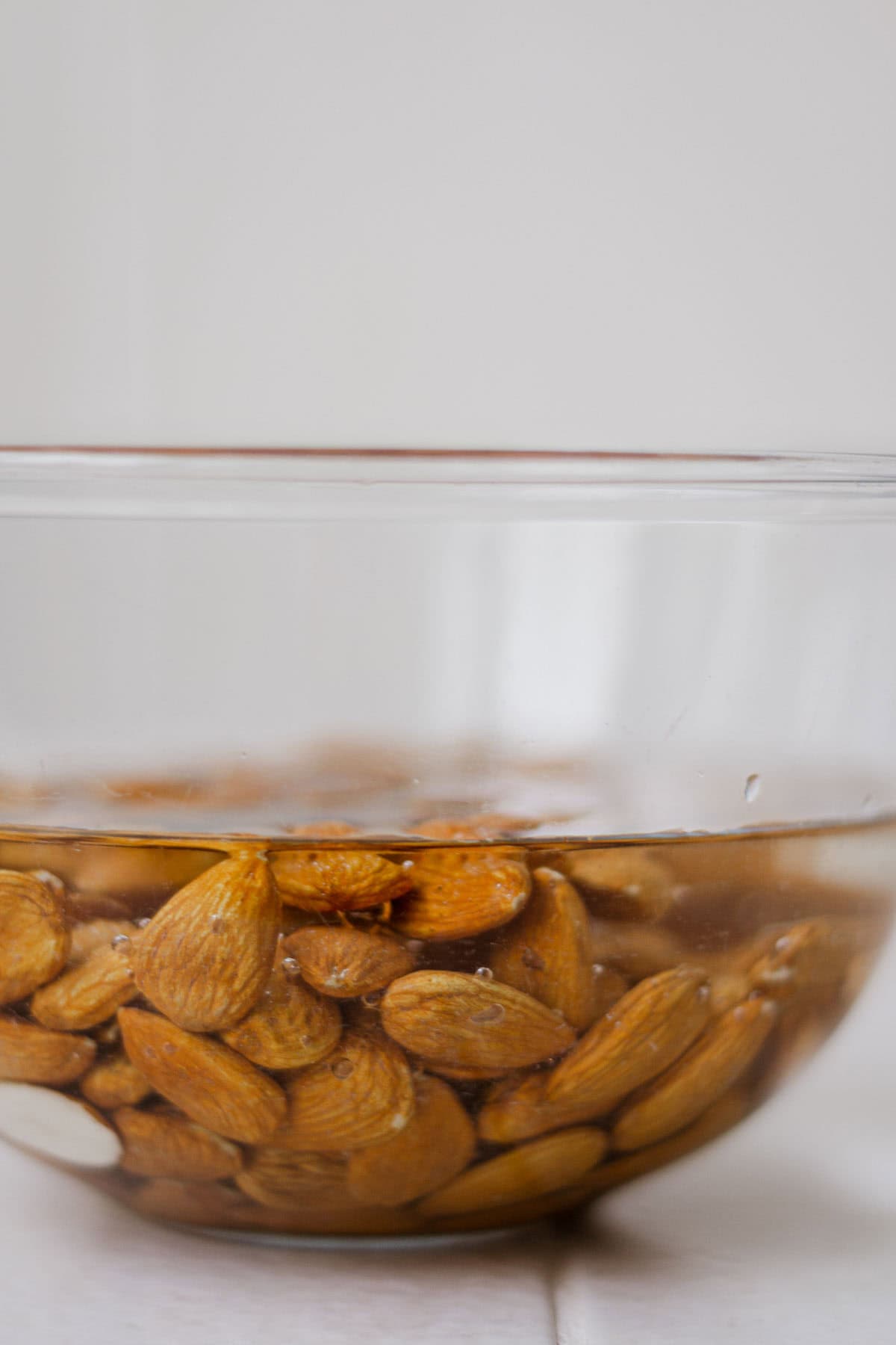 Close up of almonds submerged in vinegar.