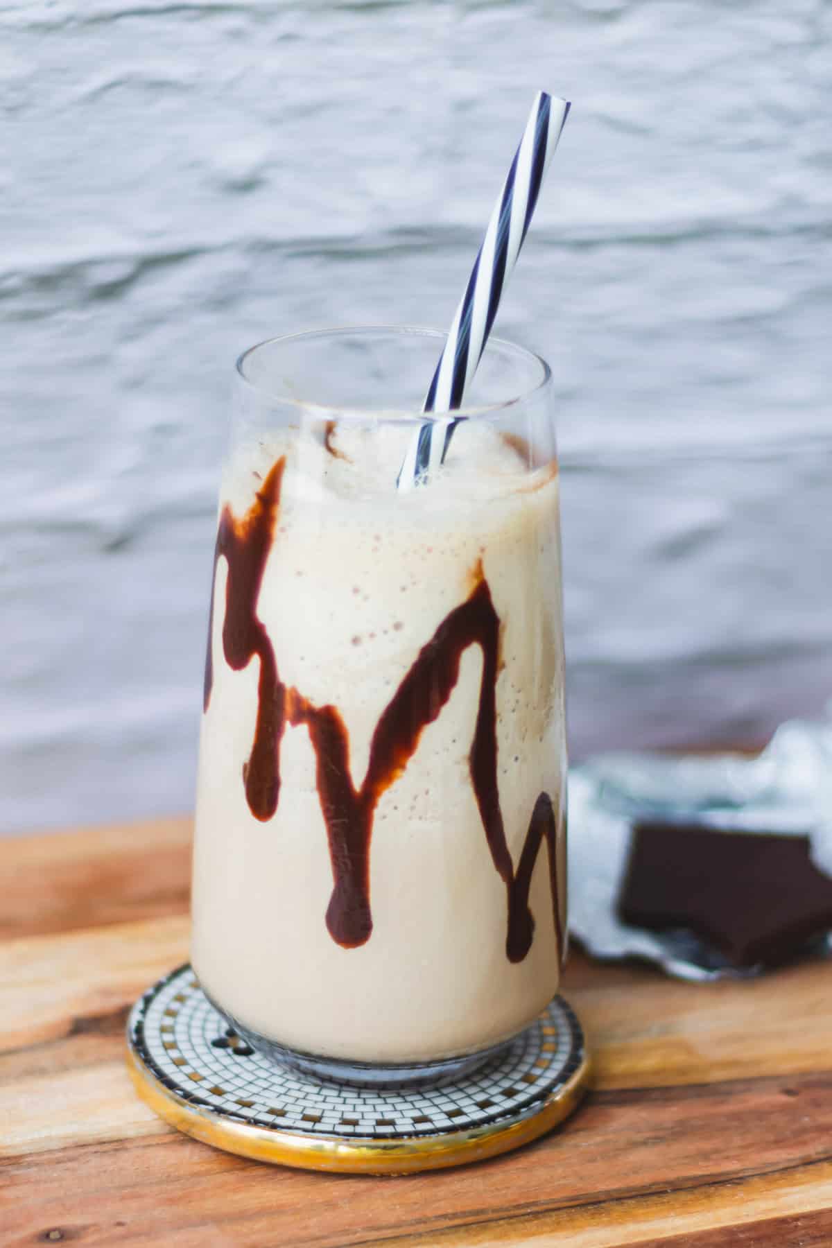 Close up of mocha shake with chocolate dripping inside the glass.