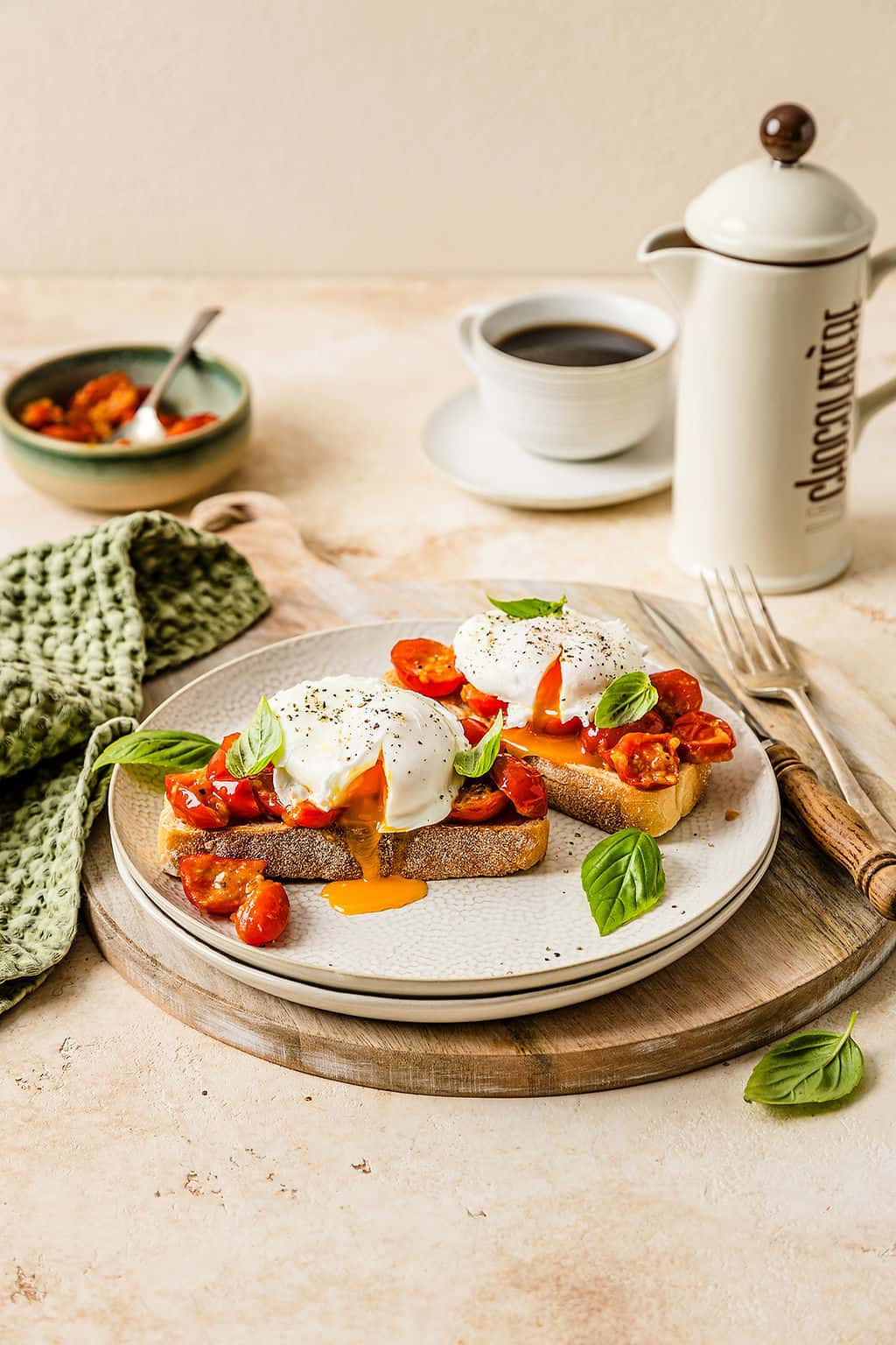 Close up showing Breakfast bruschetta on a plate, topped with a runny poached egg.