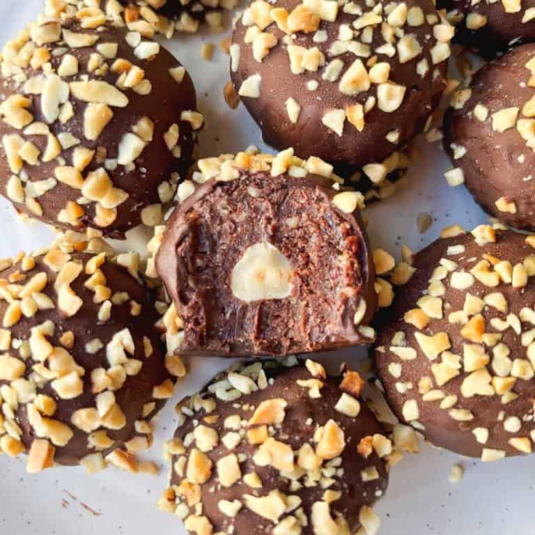 Rich chocolate truffles covered in chopped nuts, decadent homemade chocolate truffles with creamy filling topped with crunchy chopped nuts, perfect for dessert or gift, made with quality ingredients for a sweet treat.