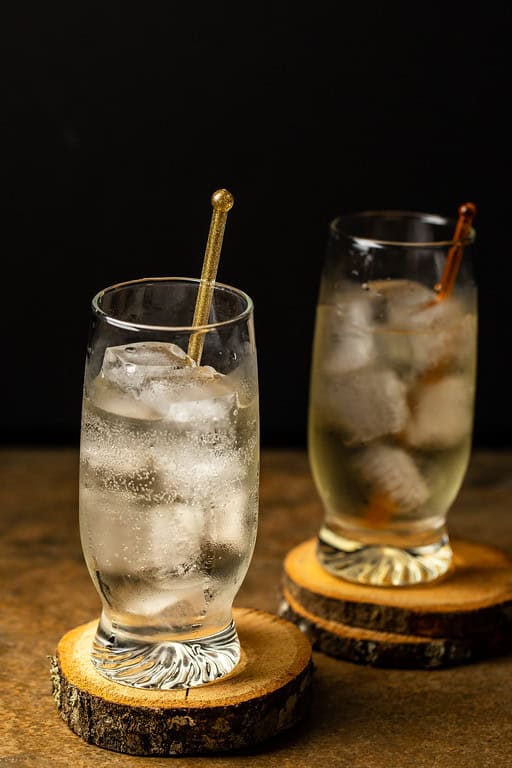 Two Japanese highballs served in tall glasses with ice.