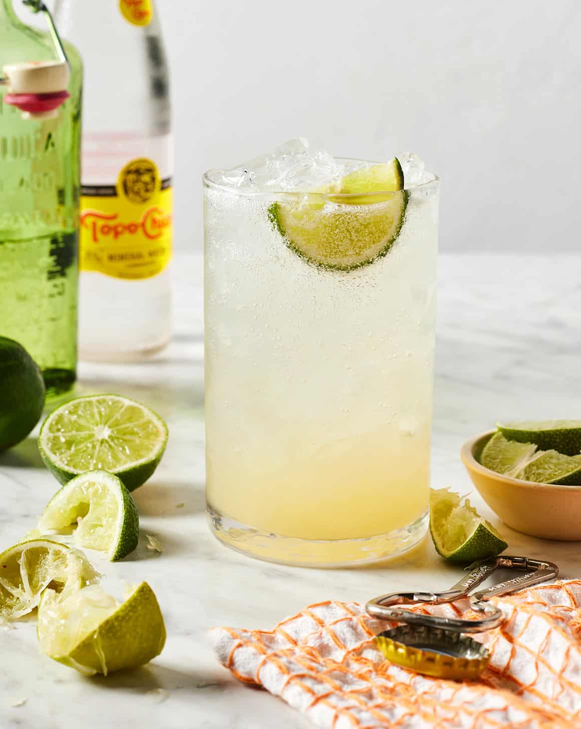 Ranch Water cocktail in a glass with ice and a lime wedge.