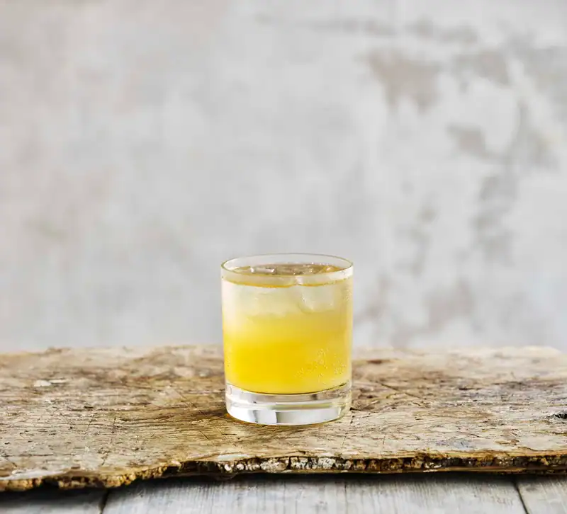 Sake Cider fizz in a rocks glass, served with ice.